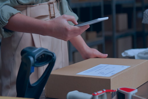 A person checking shipment details using a phone
