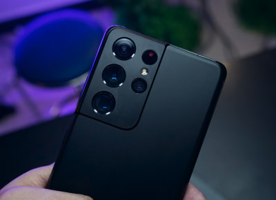 A person holding a black mobile phone