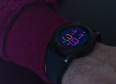 A human hand wearing a black watch