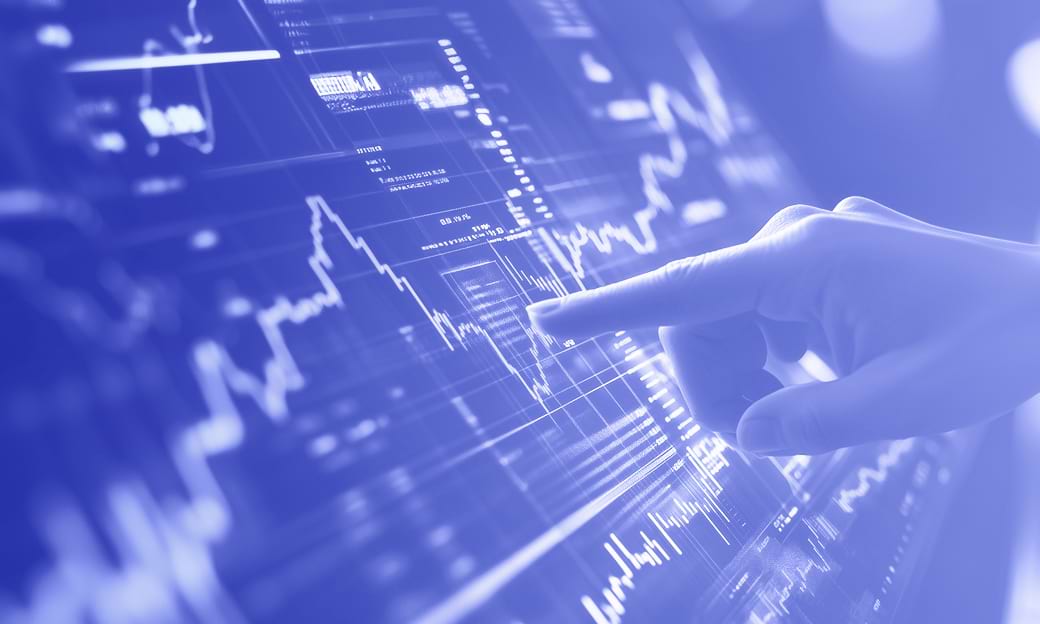 Hand pointing at digital financial chart with rising graphs