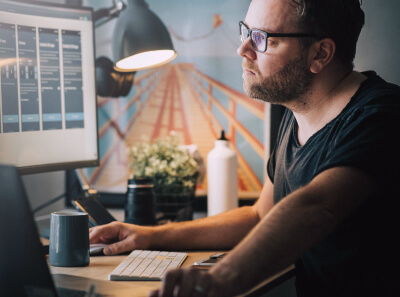  A person working o case studies sitting in front of a monitor

