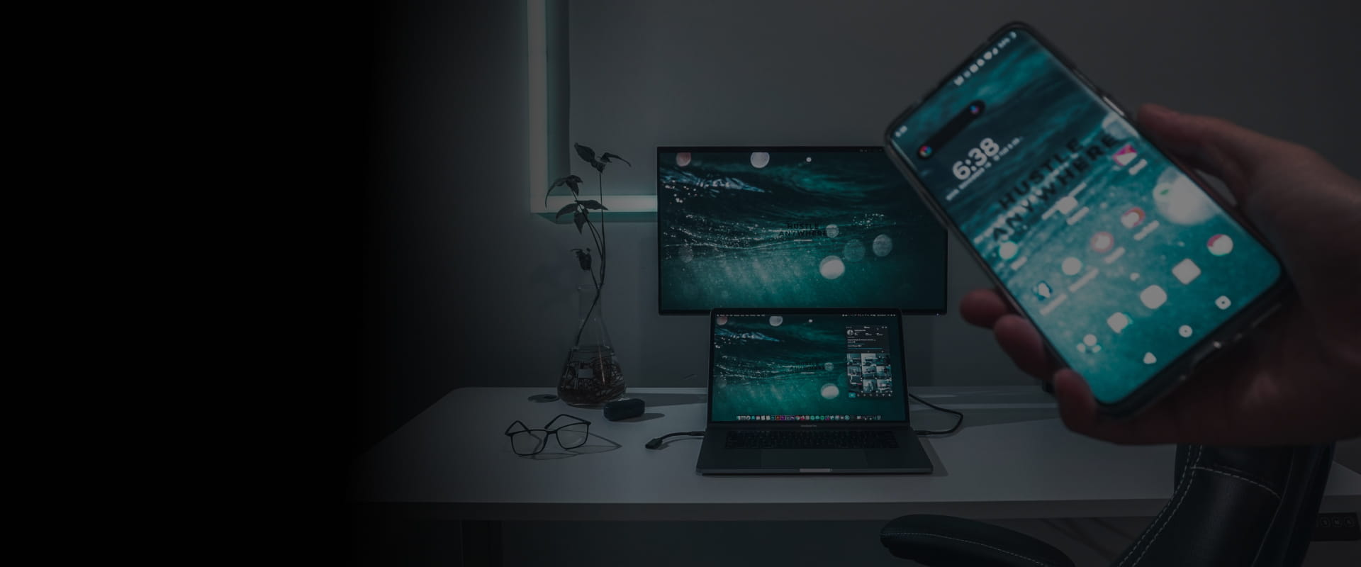 A person synchronizing a mobile, a desktop, and a tablet