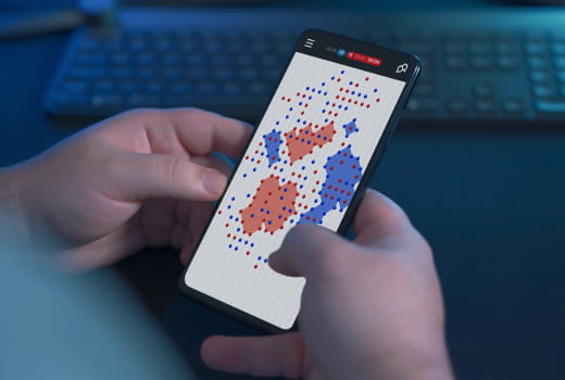 A person plays the Dots game on a phone