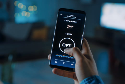 A person controlling smart home appliances using a mobile app