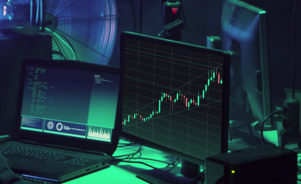 Two monitors demonstrating crypto arbitrage statistics diagrams