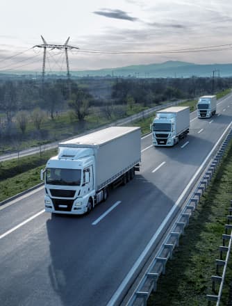 Trucks transport goods on a highway