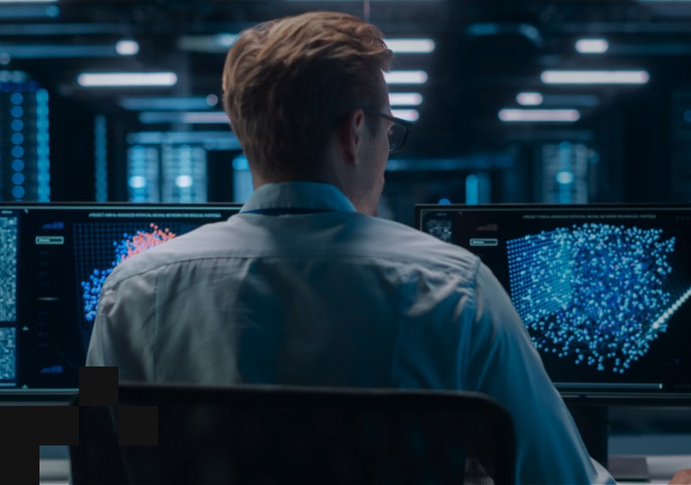 A person sitting in front of a monitor makes a call