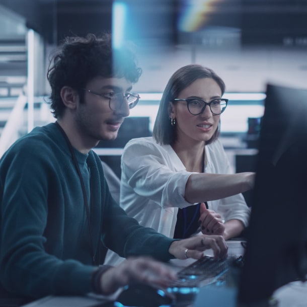 A person in an orange sweater provides eCommerce and retail software development consultation via a laptop