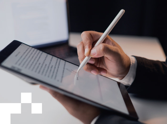 A person signing up the document on a tablet