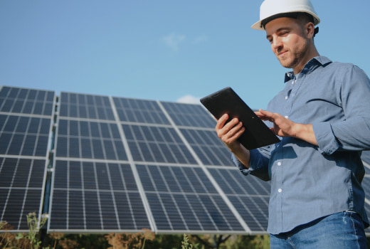 A person monitoring solar panels status on a tablet