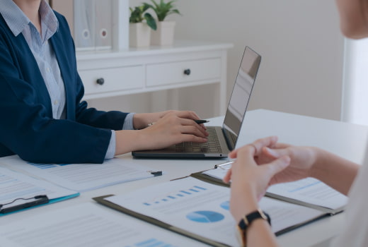 Two people discussing real estate using a document management system