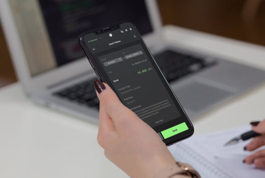 A person making operations with a token on a phone