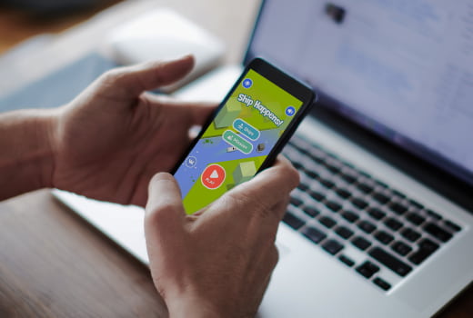 A person playing Ship Happens! on a phone