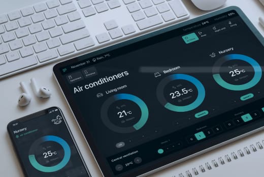 Digital devices on a table with an opened Smart home app