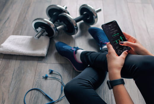 A person studying the training statistics on a phone