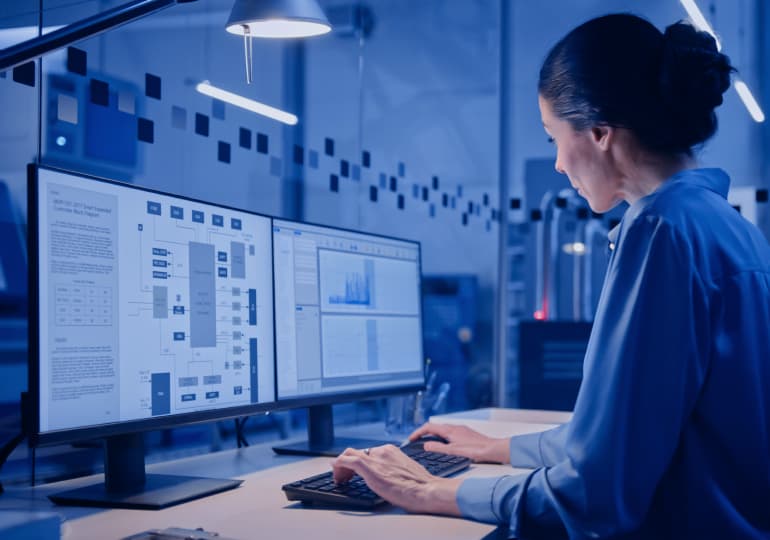 A person examining a scheme and charts