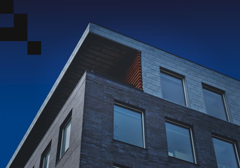 View of a grey building from the ground perspective