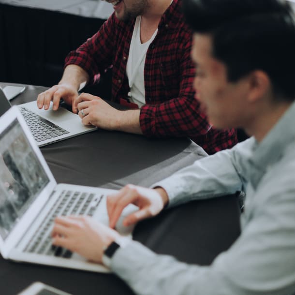 Two people in the working space operating laptops