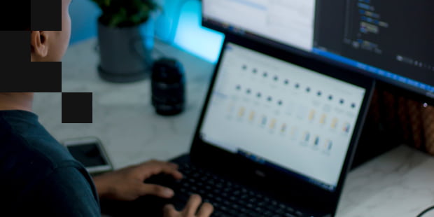 A person scrolling through files on a laptop