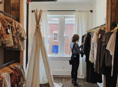 A person in a clothing store looking for new items