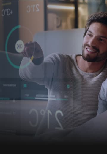 Man and woman adjust the temperature at home while sitting on the couch