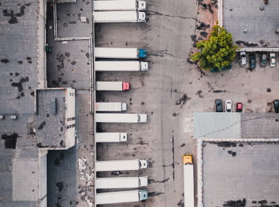 A few trucks leaving a warehouse to deliver goods