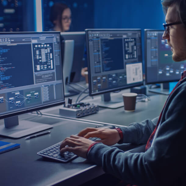 A person in front of a monitor providing web development services