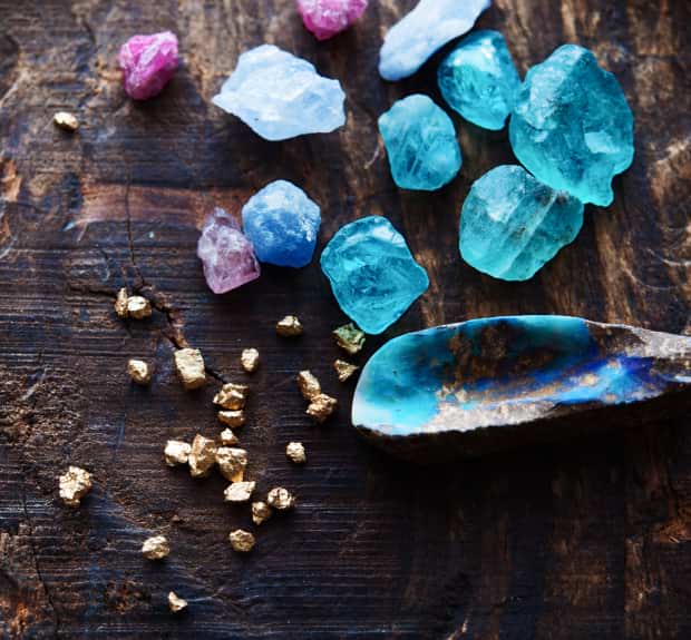 Blue and gold crystals arranged on a wooden table, showcasing their vibrant colors and natural textures.